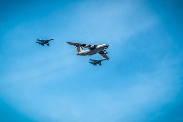 Military fighter planes are flying in the blue sky. Transportation
