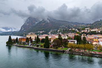 Naklejka premium Menaggio resort town on Lake Como, from above on a cloudy day. Historical buildings and landscapes