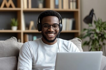 A young man in a modern living room engaged in a video call on his laptop