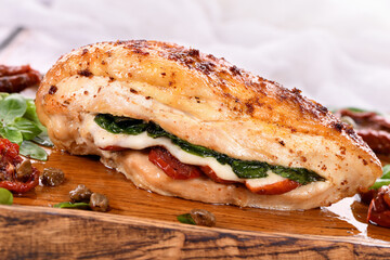 Baked chicken breast with spinach, sun-dried tomatoes and mozzarella