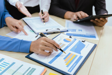 A collaborative office environment where professionals brainstorm, discuss strategy and work together to drive growth, innovation and leadership across business areas.