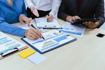 A collaborative office environment where professionals brainstorm, discuss strategy and work together to drive growth, innovation and leadership across business areas.