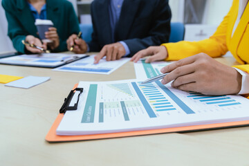 A busy office environment where teams collaborate on creative projects, finance, and marketing strategies using data, charts, and reports, engaging in brainstorming and training sessions to achieve bu