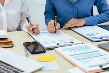 In dynamic corporate offices, teams meet strategically, discussing financial, marketing, and investment plans, using data and reports to drive success through communication.