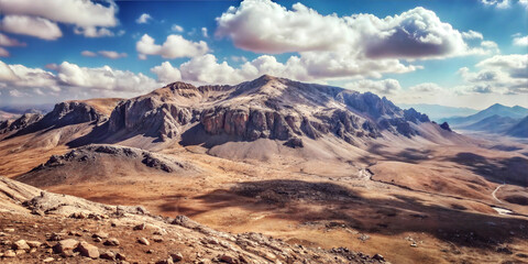 Breathtaking mountain landscape with dramatic clouds and golden plains in the background