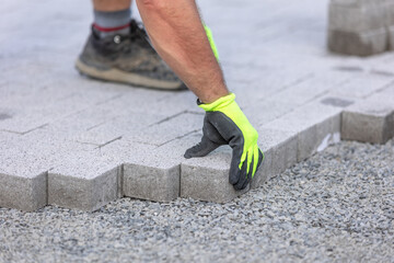 Man worker building a new path from concrete pavement, building concept