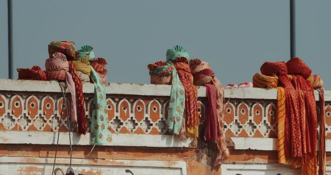 Close-up View On Multicolored Indian Turbans Lie On Parapet. Pagri Or Pagari, Is Term For Turban Used In Indian Subcontinent. Pagri Is Symbol Of Honour And Respect Everywhere It Is Worn. Cultures