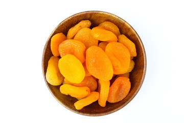 Dried Apricots in a wooden bowl on white background top view 