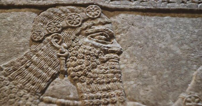 Close-up view on Winged Figure. Architectural Fragment Of Panel From Northwest Palace Of Ashurnasirpal Ii By Neo Assyrian Period. Depicted Is Winged Human Divine Spirit, Protective Spirit. High Priest
