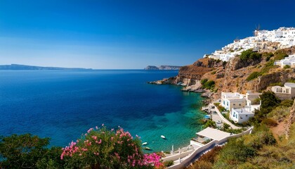 A beautiful iconic view of the Greek coast with white houses on the mountain and blue sea water on a sunny summer day