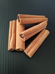 cinnamon sticks on a black background