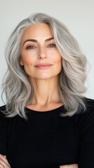 Naklejka premium A close-up of a woman with natural gray hair, styled elegantly, with a focus on the texture and beauty of aging hair, celebrating confidence and individuality
