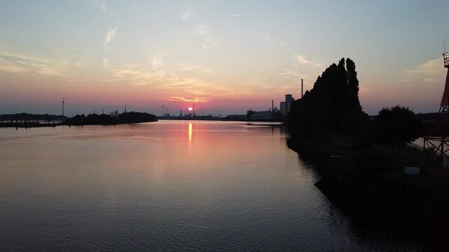 drone flies above river Weser in Bremen in to sunset 