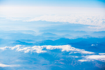 A view of the planet Earth, a view from an airplane, mountains and clouds