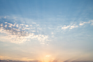 Obraz premium Beautiful sunset or sunrise, sky with clouds, sun rays breaking through the clouds, magical, fabulous natural background, serenity and calm
