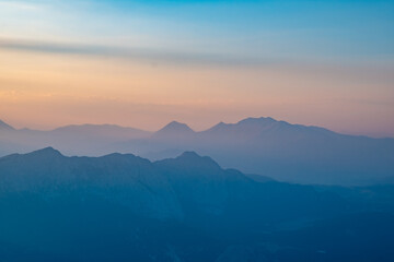 Silhouettes of mountains in a beautiful gentle haze, mountains at sunset or sunrise, natural...