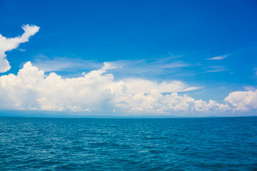 Blue sky with fluffy cloud in sea background