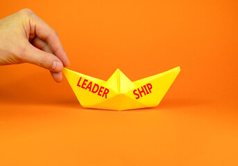 Leadership symbol. Concept word Leadership on beautiful yellow paper boat. Beautiful orange...