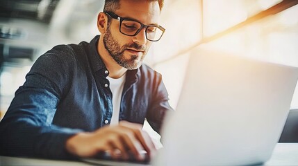 Fototapeta premium Creative Studio Magic: Graphic Designer in Glasses, Laptop Work, Modern Workspace, Design Inspiration, and Artistic Ambiance