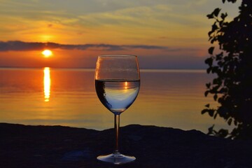 Glass of white wine at sunset.