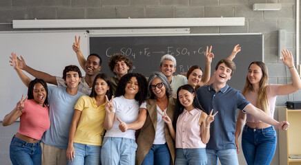 Portrait of a group diverse teenage students with female teacher in class. High school, university