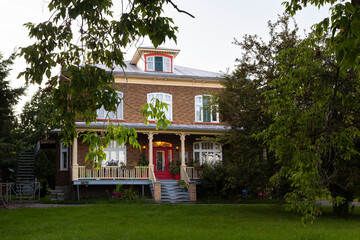 Beautiful large 19th Century neo-classical brown brick house with covered porch, arched windows and...