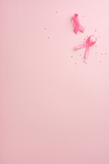 Two pink ribbons on a pastel background representing breast cancer awareness, highlighting support and hope