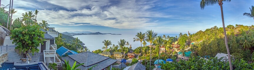 Fototapeta premium View over an infinity pool on a slope above a tropical beach