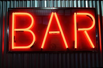 Fototapete Bar Bright red neon sign of bar word in front of striped metal wall at night. Luminous glowing light from retro style lamp illuminates urban nightlife scene.  © Viktor