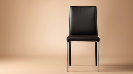 A contemporary dining chair in black leather, with sleek metal legs, standing alone on a neutral beige background.
