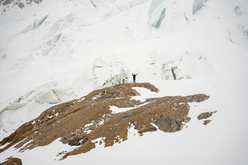 A group of people walking on the snowy mountains with their snowshoes on. Climbing the icy mountains