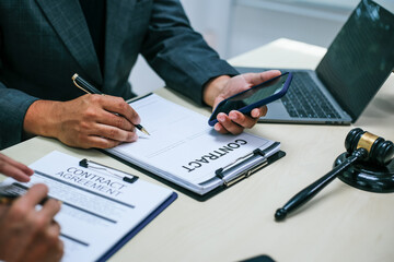 Two lawyers consult in a modern office, presenting compelling arguments and demonstrating their expertise, trying to win a case with their legal acumen and persuasive skills.
