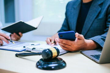 Two lawyers consult in a modern office, presenting compelling arguments and demonstrating their...