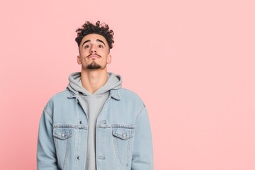 Fototapeta premium Casual Young Man Posing in Front of Pink Backdrop