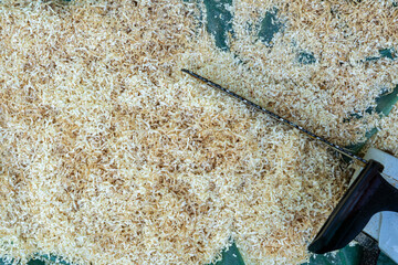 Yellow wood chipping, mulch created by cutting wood with chainsaw to be recycled on plants. Top...