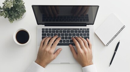 A man is typing on a laptop with a cup of coffee next to him. Concept of productivity and focus, as the man is working on his computer while enjoying a hot beverage