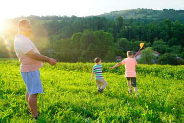 Kids playing with scoop-net on the meadow on warm and sunny summer