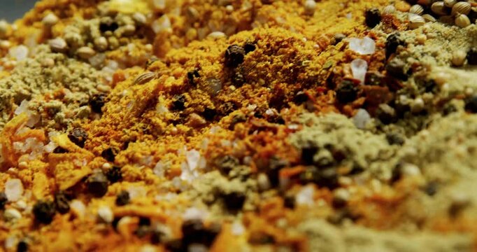 Close-up showing various colorful spices, animated and moving in vibrant display