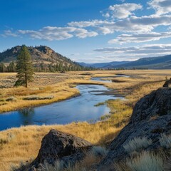 Serene river winding through golden grasslands in a tranquil valley