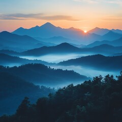 Obraz premium Breathtaking sunrise over misty mountains, showcasing layered peaks and serene valleys enveloped in morning fog.