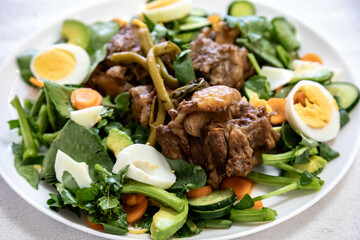 Beef oxtail cooked with watercress and served with salad. Hearty and nutritious low carb food