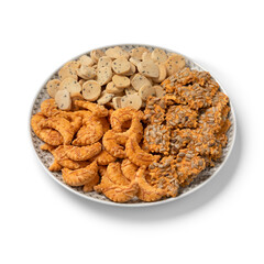 Plate with a variation of traditional Krichlate spicy miniature shortbread cookies close up isolated on white background