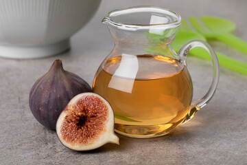 Glass jar with homemade fig vinegar and fresh figs close up