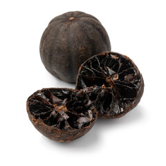 Whole and halved dried black limes, loomi, isolated on white background close up