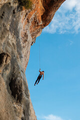 Climber with rope. A young man is engaged in rock climbing.
