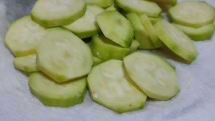 sliced cucumber on a white background