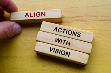 Align actions with vision text on wooden blocks. Operational Excellence concept