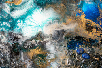 Closeup of epoxy resin with natural minerals, crystals and stones, painting of geode mixing vibrant...