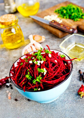 delicious fresh beet salad on gray stone background.