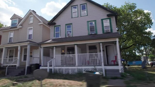City and townhouses housing and residential homes on outskirts of downtown center of Columbus, Ohio in the midwest part of the United States in a low income and middle class suburb and neighborhood